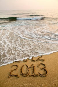 2013 and 2012 written in sand with waves